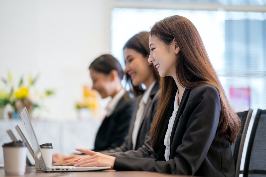 Asian businessmen are working with laptops in the office.